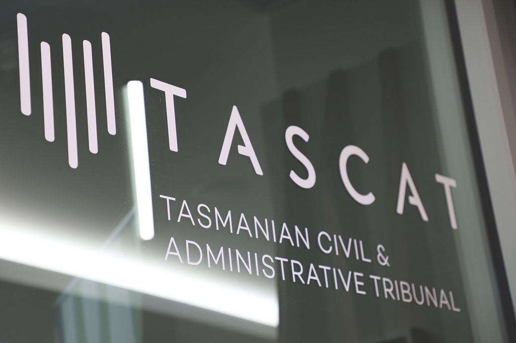 TASCAT sign on a window at TASCAT, in white lettering with the TASCAT logo